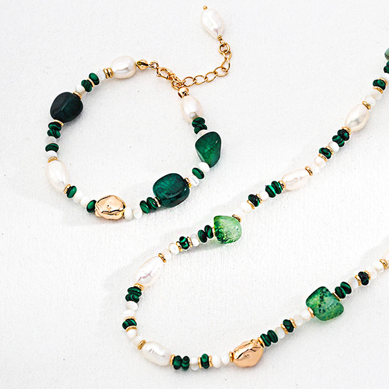 Flat lay display of pearl, malachite, and green agate jewelry set with S925 silver accents in layered styling.