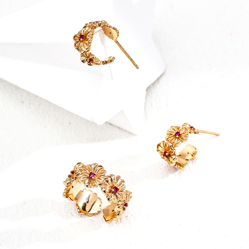 Golden flower-inspired earrings and ring set with ruby-red zircon detailing, designed in S925 silver.