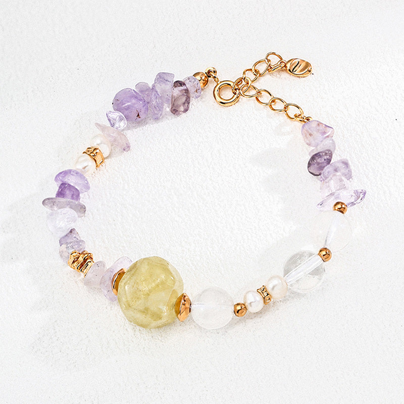 A softly arranged S925 silver bracelet featuring a central faceted yellow crystal, surrounded by amethyst chips, translucent quartz, freshwater pearls, and golden accent beads—evoking a gentle, nature-inspired palette.