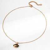 Full view of a dainty S925 silver chain necklace with a tiger's eye gemstone pendant in retro gold-toned wrapping, laid flat against a white background.