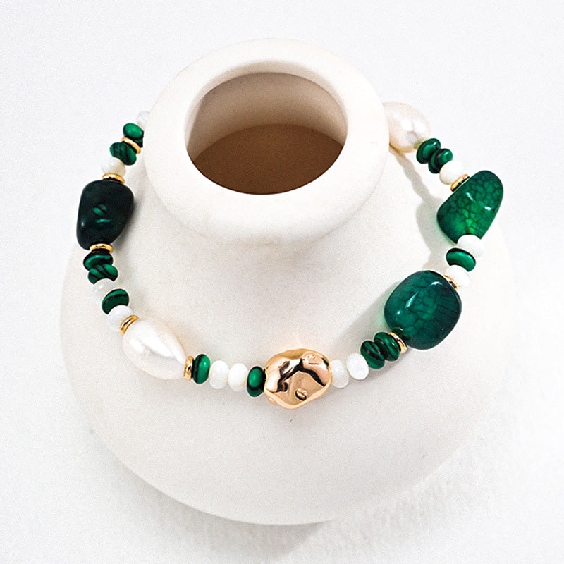 Beaded bracelet with S925 silver, freshwater pearls, malachite, and dark green agate, styled on a white ceramic vase.