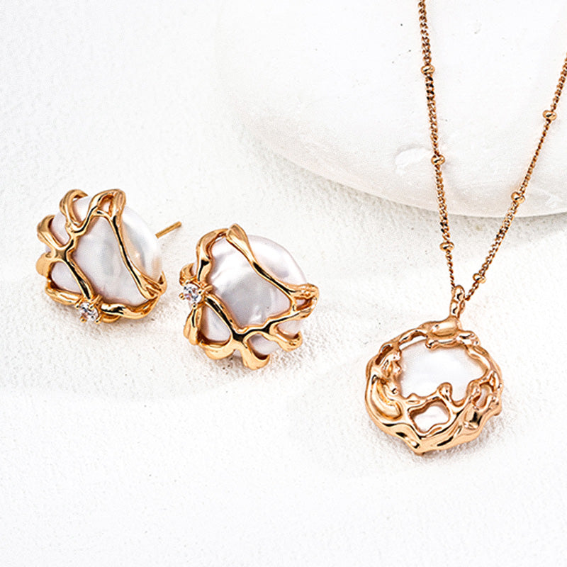 A jewelry set showcasing S925 silver gold-tone earrings and matching pendant necklace, all featuring irregular pearls and fluid metalwork with zircon embellishment.