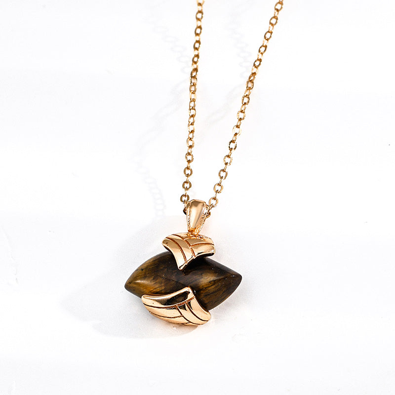 Close-up of a vintage-style S925 silver necklace featuring a polished tiger's eye gemstone wrapped in sculpted gold-toned metal, radiating strength and elegance.