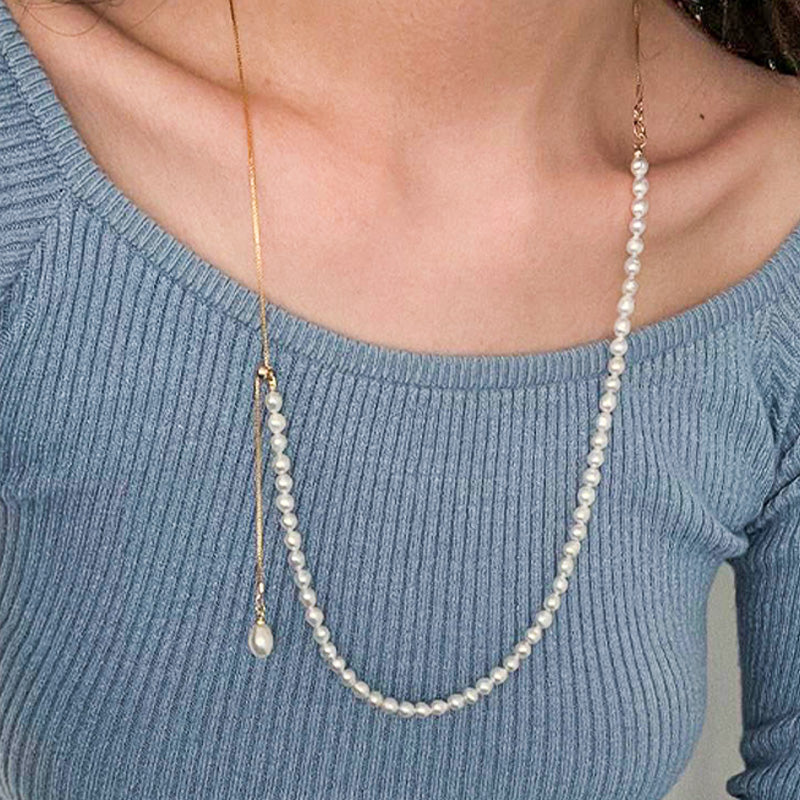 Elegant double-layer pearl necklace featuring a unique U-shaped design, styled with a gold chain and white freshwater pearls for modern layering.