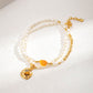 Delicately crafted freshwater pearl Pendant featuring an integrated tiger's eye, accented with a vibrant orange agate and golden detailing, blending natural elegance with artistic design.