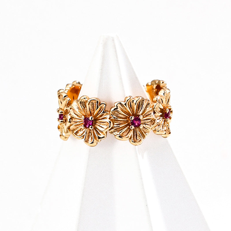 Gold-tone S925 silver ring designed with daisy-like floral motifs, each centered with a red zircon stone.