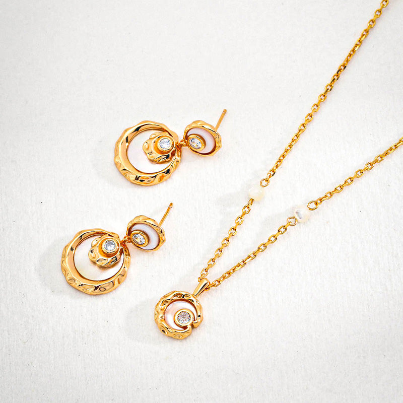 Close-up of gold-plated sterling silver necklace and earring set — mother-of-pearl and zircon details for subtle vintage brilliance.