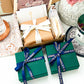 Beautifully wrapped jewelry gift boxes with elegant ribbons and personalized cards, reflecting warmth, thoughtfulness, and attention to detail.