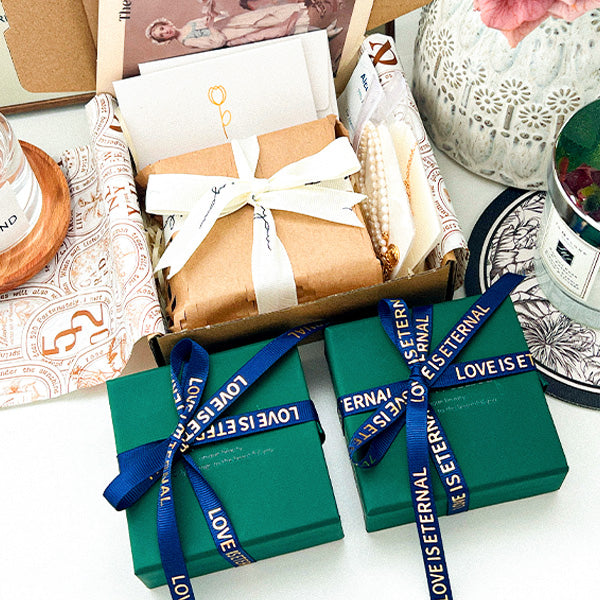 Beautifully wrapped jewelry gift boxes with elegant ribbons and personalized cards, reflecting warmth, thoughtfulness, and attention to detail.