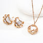 A jewelry set showcasing S925 silver gold-tone earrings and matching pendant necklace, all featuring irregular pearls and fluid metalwork with zircon embellishment.