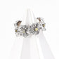 S925 silver floral ring featuring textured petals and soft yellow zircon stones at the center of each bloom.
