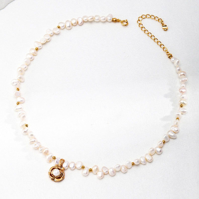 Flat lay of the Camellia Pearl Necklace with 925 silver camellia pendant and irregular freshwater pearls — elegant and meaningful.