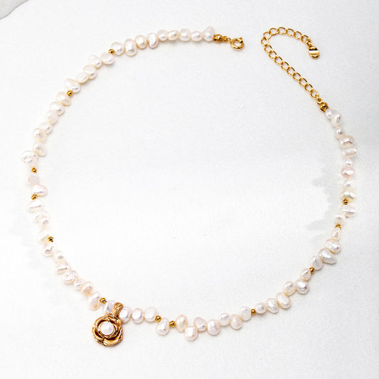 Flat lay of the Camellia Pearl Necklace with 925 silver camellia pendant and irregular freshwater pearls — elegant and meaningful.