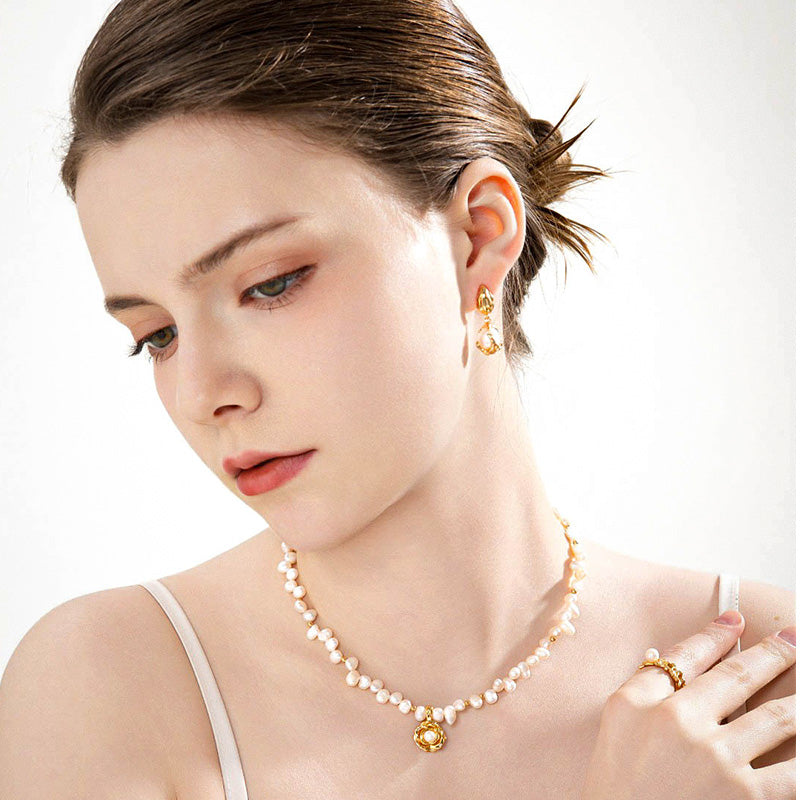 A graceful look featuring the Camellia Pearl Necklace, crafted from sterling silver and pearls, expressing quiet elegance and sincerity in love.