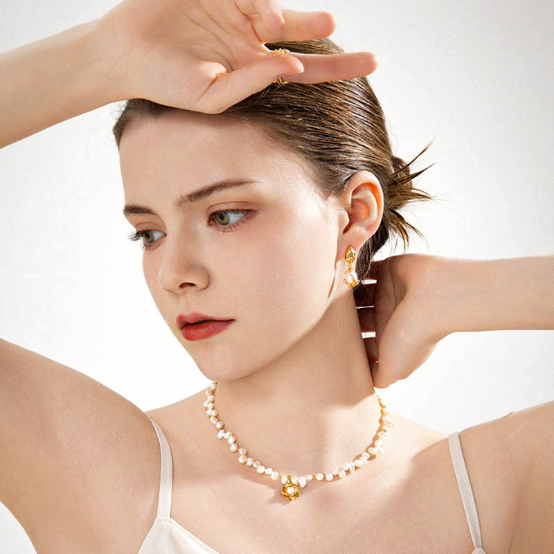 The Camellia Pearl Necklace glowing softly in a bright pose — symbolising pure and beautiful love through the camellia flower design.