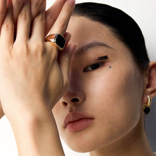 Close-up of a model wearing a gold S925 silver black onyx signet ring — a sleek, intentional piece that speaks in silence.