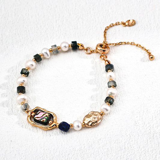 Top view of a handcrafted bracelet in S925 silver, featuring abalone shell, moss agate cubes, deep blue lapis, and softly glowing pearls — a symbol of grounded beauty.