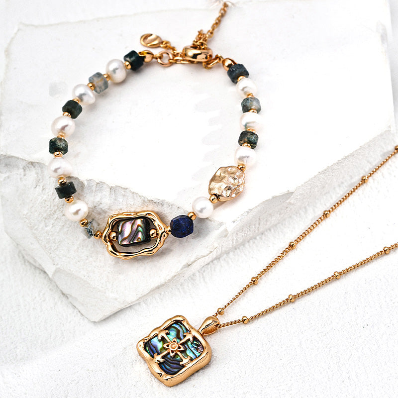 S925 silver bracelet and necklace set featuring iridescent abalone, freshwater pearls, lapis lazuli, and moss agate — a poetic blend of earth and ocean energy.