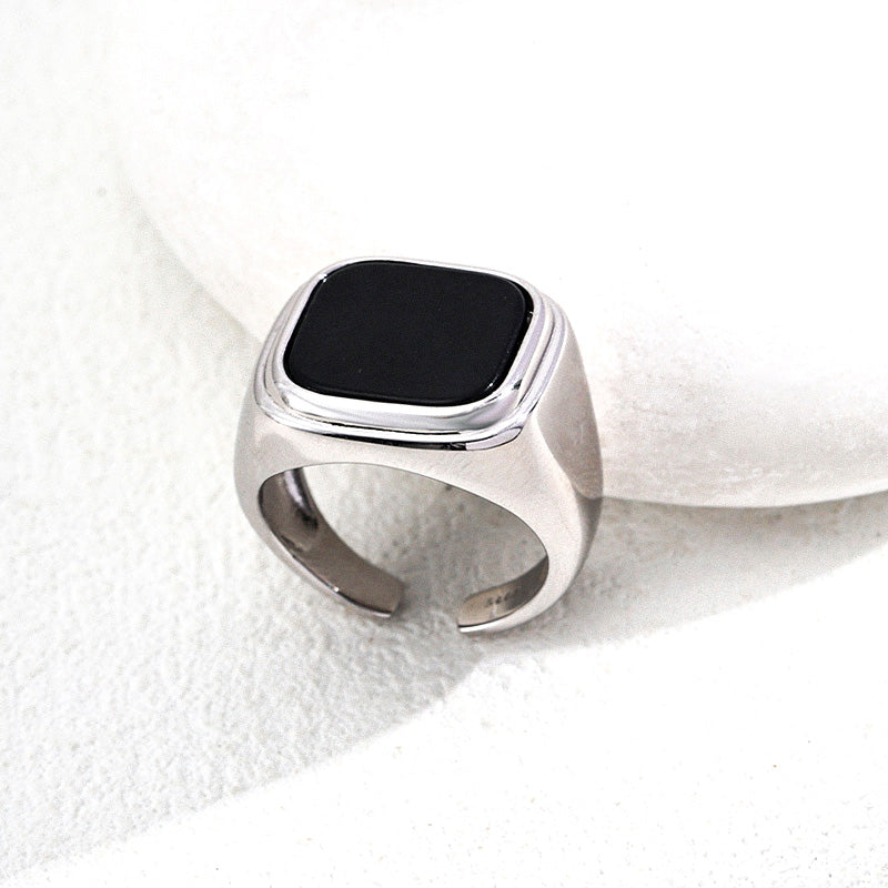 Silver-toned S925 black onyx ring styled with soft light — minimal, masculine, and made for presence.