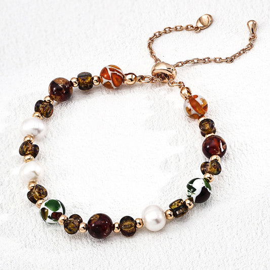 S925 silver bracelet featuring natural pearls and iridescent glass shell beads — a vintage-inspired piece with warm tones and whimsical details.